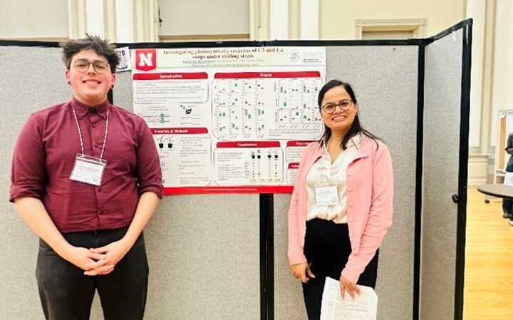 Gabriel and Seema in front of the poster at ASPB